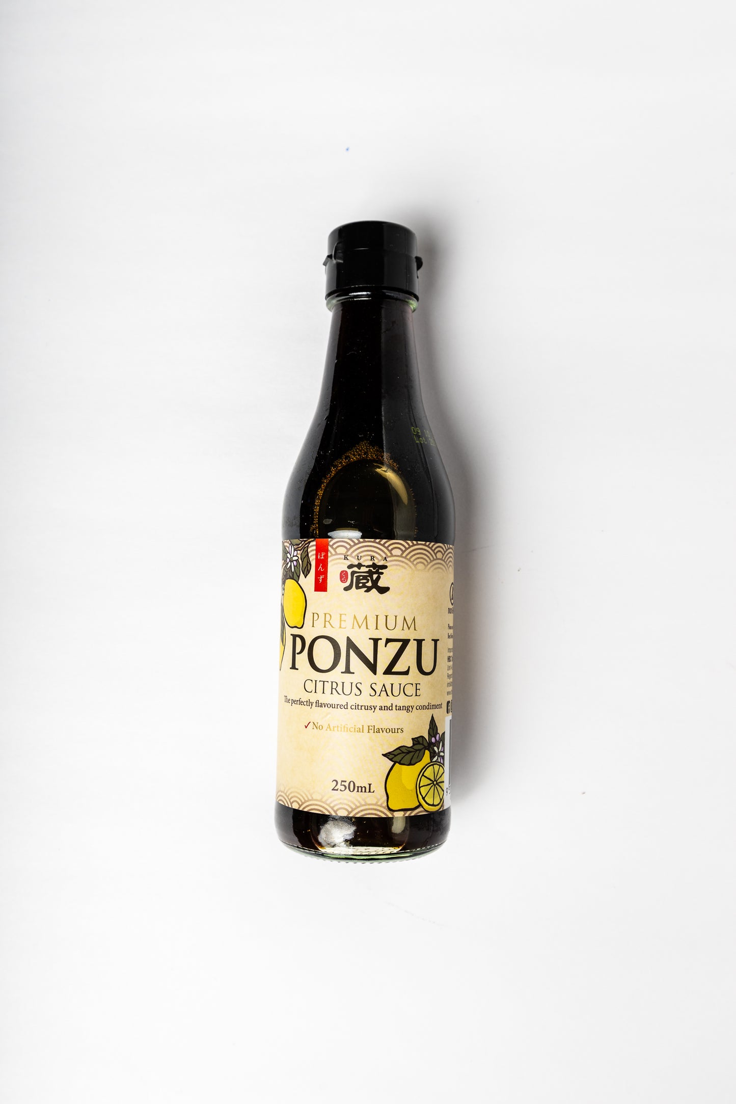 A bottle of Premium Ponzu Citrus Sauce on a plain white background. The bottle is dark glass with a black cap and a beige label featuring yellow citrus graphics.