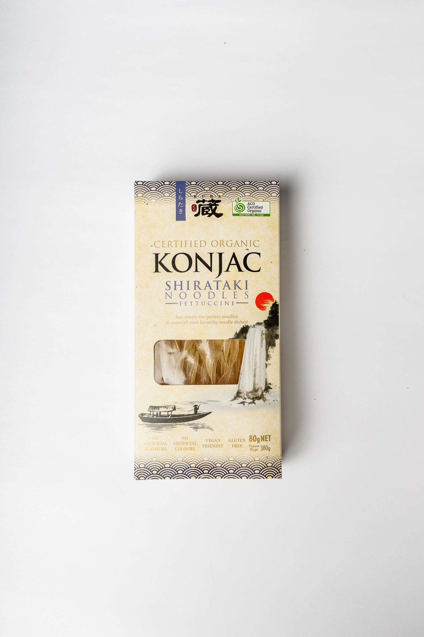 A package of Konjac Shirataki Noodles (Fettuccine) by The Farm Store, featuring a cream-colored box with Japanese-style illustrations and a clear window showing the dried noodles inside, set against a plain white background.