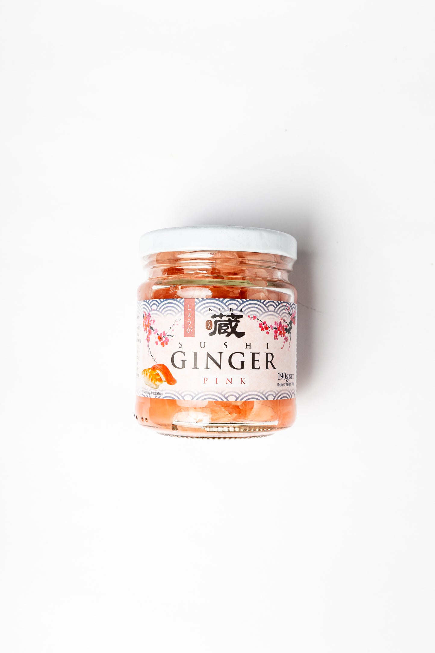 A glass jar of Sushi Ginger Pink, containing orange-red ginger and fish paste, with a white lid and a white label featuring red and black text and illustrations, set against a plain white background.