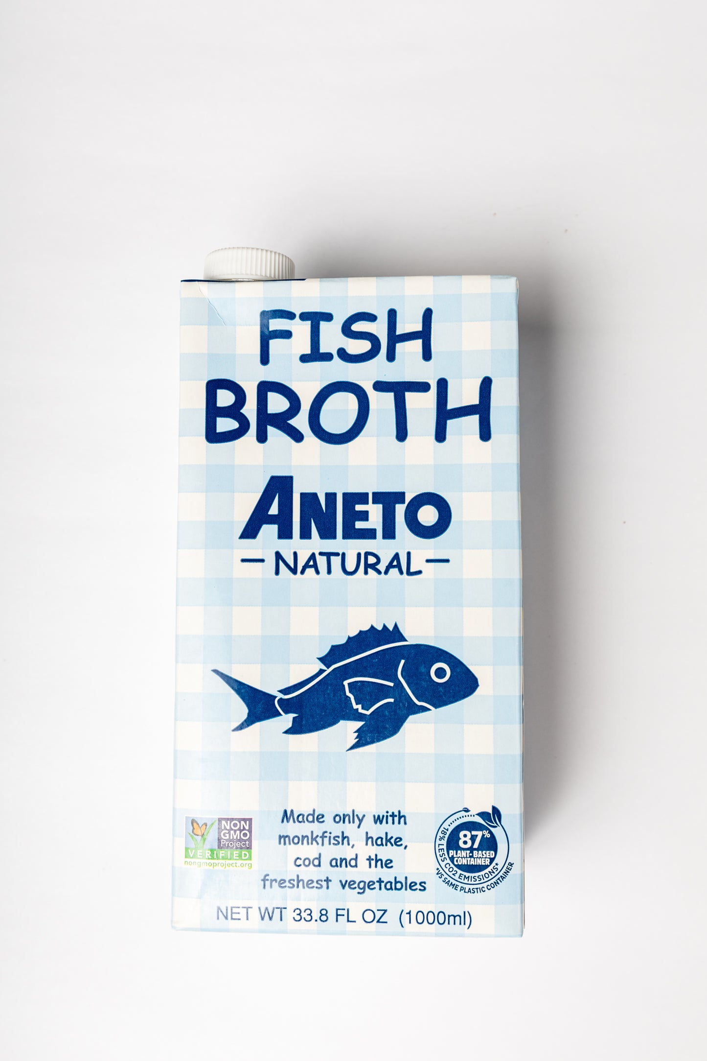 A carton of Aneto Natural Fish Broth, 33.8 fl oz (1000 ml), featuring a light blue and white gingham pattern with a dark blue fish illustration and text.