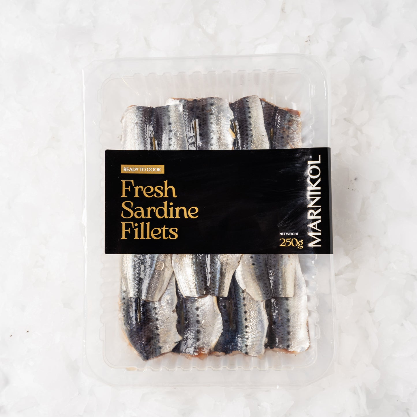 Packaged fresh sardine fillets with Marmikol branding on a light background