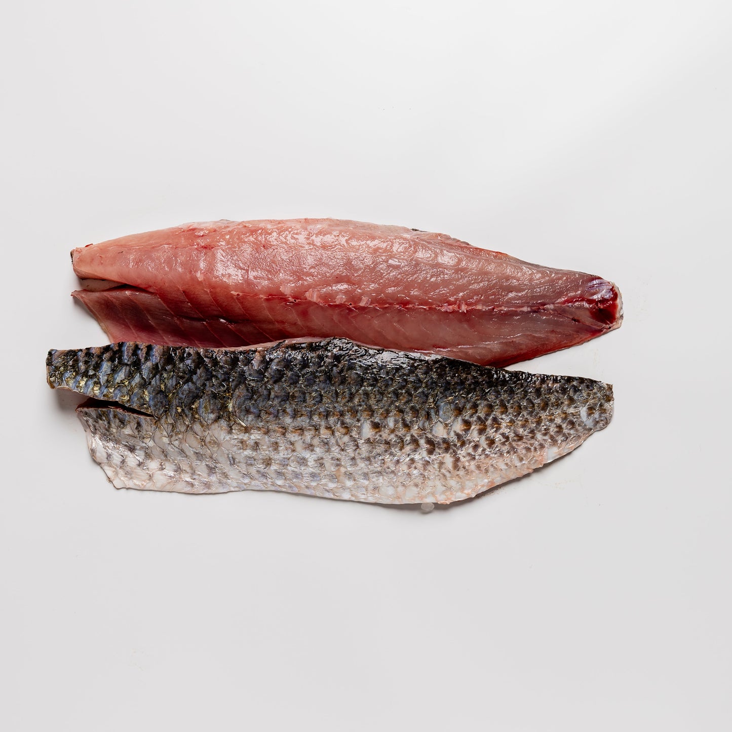 
                  
                    Two fish fillets on a white background
                  
                
