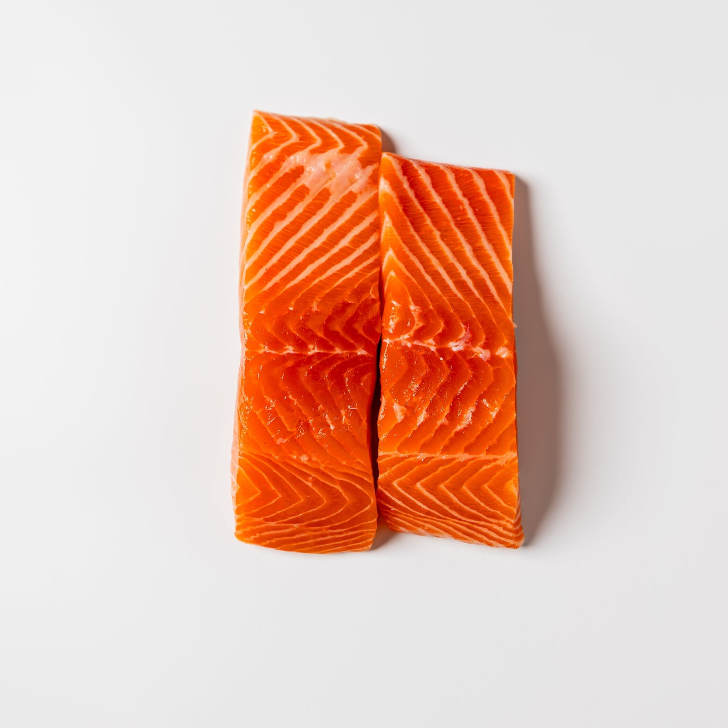 
                  
                    Two pieces of raw salmon on a white background Kailis bros
                  
                